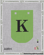 A taped needlepoint canvas with the design: Banner 18 mesh count Curved K Black on Light Green.