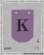 A taped needlepoint canvas with the design: Banner 18 mesh count Curved K Black on Purple.