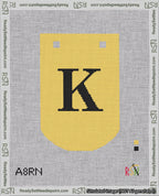 A taped needlepoint canvas with the design: Banner 18 mesh count Curved K Black on Yellow.