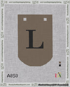 A taped needlepoint canvas with the design: Banner 18 mesh count Curved L Black on Brown.