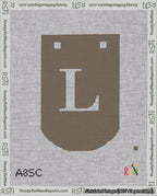A taped needlepoint canvas with the design: Banner 18 mesh count Curved L White on Brown.