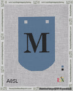A taped needlepoint canvas with the design: Banner 18 mesh count Curved M Black on Blue.