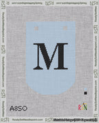 A taped needlepoint canvas with the design: Banner 18 mesh count Curved M Black on Light Blue.