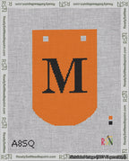 A taped needlepoint canvas with the design: Banner 18 mesh count Curved M Black on Orange.