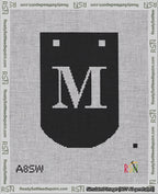 A taped needlepoint canvas with the design: Banner 18 mesh count Curved M White on Black.