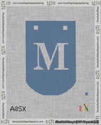 A taped needlepoint canvas with the design: Banner 18 mesh count Curved M White on Blue.