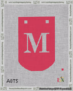 A taped needlepoint canvas with the design: Banner 18 mesh count Curved M White on Red.