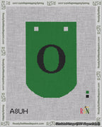 A taped needlepoint canvas with the design: Banner 18 mesh count Curved O Black on Green.