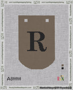 A taped needlepoint canvas with the design: Banner 18 mesh count Curved R Black on Brown.