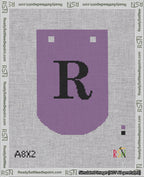 A taped needlepoint canvas with the design: Banner 18 mesh count Curved R Black on Purple.