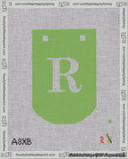 A taped needlepoint canvas with the design: Banner 18 mesh count Curved R White on Light Green.