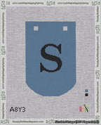 A taped needlepoint canvas with the design: Banner 18 mesh count Curved S Black on Blue.