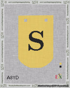 A taped needlepoint canvas with the design: Banner 18 mesh count Curved S Black on Yellow.