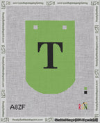 A taped needlepoint canvas with the design: Banner 18 mesh count Curved T Black on Light Green.