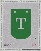 A taped needlepoint canvas with the design: Banner 18 mesh count Curved T White on Green.