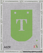 A taped needlepoint canvas with the design: Banner 18 mesh count Curved T White on Light Green.
