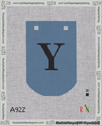 A taped needlepoint canvas with the design: Banner 18 mesh count Curved Y Black on Blue.