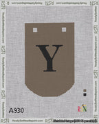 A taped needlepoint canvas with the design: Banner 18 mesh count Curved Y Black on Brown.