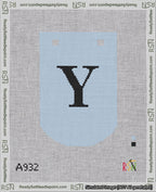 A taped needlepoint canvas with the design: Banner 18 mesh count Curved Y Black on Light Blue.