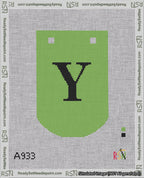 A taped needlepoint canvas with the design: Banner 18 mesh count Curved Y Black on Light Green.