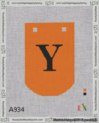 A taped needlepoint canvas with the design: Banner 18 mesh count Curved Y Black on Orange.