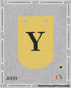 A taped needlepoint canvas with the design: Banner 18 mesh count Curved Y Black on Yellow.