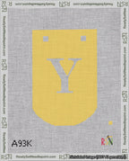 A taped needlepoint canvas with the design: Banner 18 mesh count Curved Y White on Yellow.