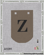 A taped needlepoint canvas with the design: Banner 18 mesh count Curved Z Black on Brown.