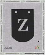 A taped needlepoint canvas with the design: Banner 18 mesh count Curved Z White on Black.