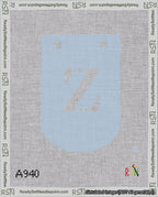 A taped needlepoint canvas with the design: Banner 18 mesh count Curved Z White on Light Blue.