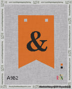 A taped needlepoint canvas with the design: Banner 18 mesh count Forked Ampersand Black on Orange.