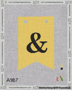 A taped needlepoint canvas with the design: Banner 18 mesh count Forked Ampersand Black on Yellow.