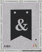 A taped needlepoint canvas with the design: Banner 18 mesh count Forked Ampersand White on Black.