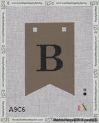 A taped needlepoint canvas with the design: Banner 18 mesh count Forked B Black on Brown.