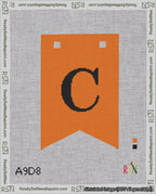 A taped needlepoint canvas with the design: Banner 18 mesh count Forked C Black on Orange.