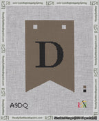 A taped needlepoint canvas with the design: Banner 18 mesh count Forked D Black on Brown.