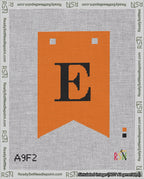 A taped needlepoint canvas with the design: Banner 18 mesh count Forked E Black on Orange.