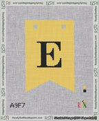 A taped needlepoint canvas with the design: Banner 18 mesh count Forked E Black on Yellow.