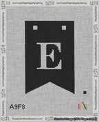 A taped needlepoint canvas with the design: Banner 18 mesh count Forked E White on Black.