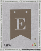 A taped needlepoint canvas with the design: Banner 18 mesh count Forked E White on Brown.