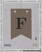 A taped needlepoint canvas with the design: Banner 18 mesh count Forked F Black on Brown.