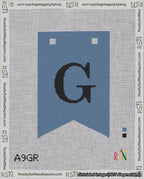 A taped needlepoint canvas with the design: Banner 18 mesh count Forked G Black on Blue.