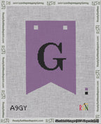 A taped needlepoint canvas with the design: Banner 18 mesh count Forked G Black on Purple.