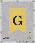 A taped needlepoint canvas with the design: Banner 18 mesh count Forked G Black on Yellow.