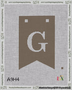 A taped needlepoint canvas with the design: Banner 18 mesh count Forked G White on Brown.