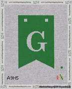 A taped needlepoint canvas with the design: Banner 18 mesh count Forked G White on Green.