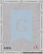 A taped needlepoint canvas with the design: Banner 18 mesh count Forked G White on Light Blue.