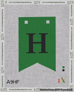 A taped needlepoint canvas with the design: Banner 18 mesh count Forked H Black on Green.