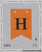 A taped needlepoint canvas with the design: Banner 18 mesh count Forked H Black on Orange.