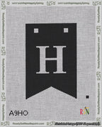 A taped needlepoint canvas with the design: Banner 18 mesh count Forked H White on Black.